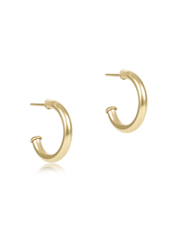 Smooth gold hoop earrings on a white background