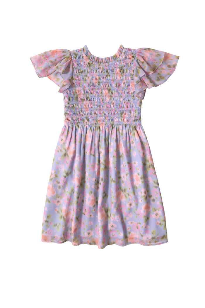 The Mini Lottie Dress in Vibrant English Garden by Ivy City Co is a girls’ midi dress with ruffled sleeves, a smocked bodice, and a pastel floral print in pink, green, and purple on light purple.