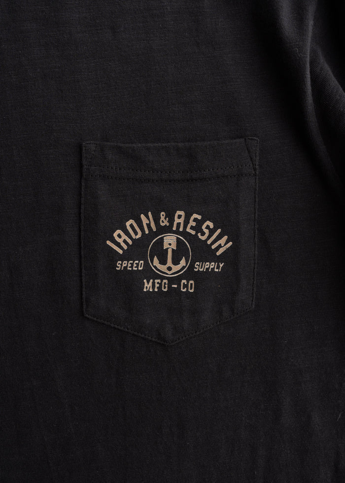 7.5 oz 100% Combed Cotton t-shirt in Black, close-up shot to showcase fabric detail, custom graphic and chest pocket