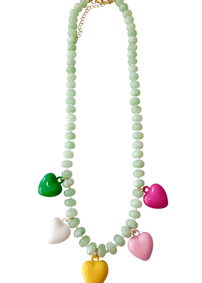 Green beaded necklace with five colored heart charm necklaces on a white background
