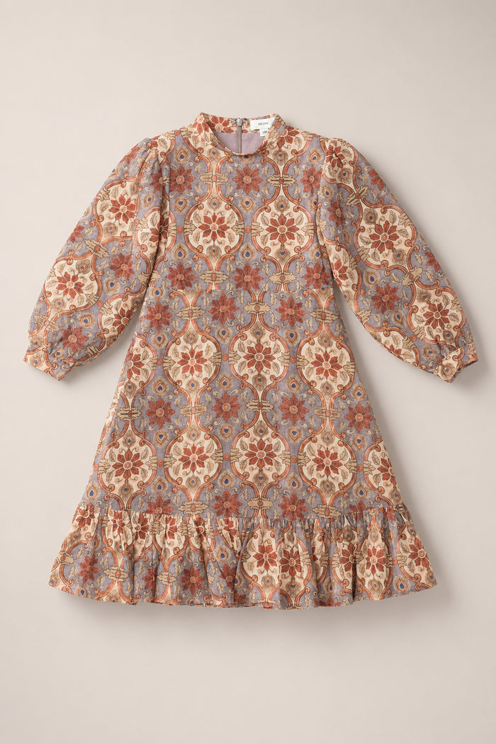The Teen Draper Dress in Golden Hour Tesserae by Ivy City Co features long sleeves, a floral and geometric pattern in red, cream, and blue hues, elegant balloon sleeves, and a ruffled hem—making it a chic choice for fall.