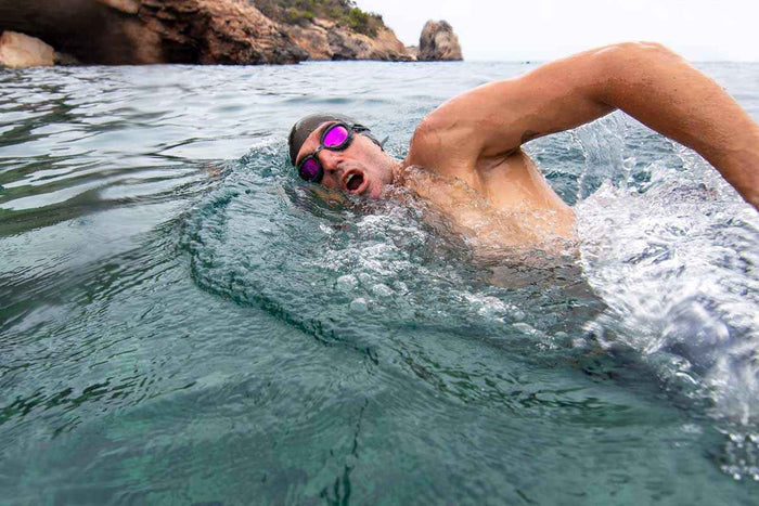 Zoggs Predator Titanium swimming goggles in regular fit with grey, black, and mirrored pink lenses, designed for comfortable swimming.